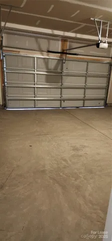 a view of a white house with a large windows and a yard