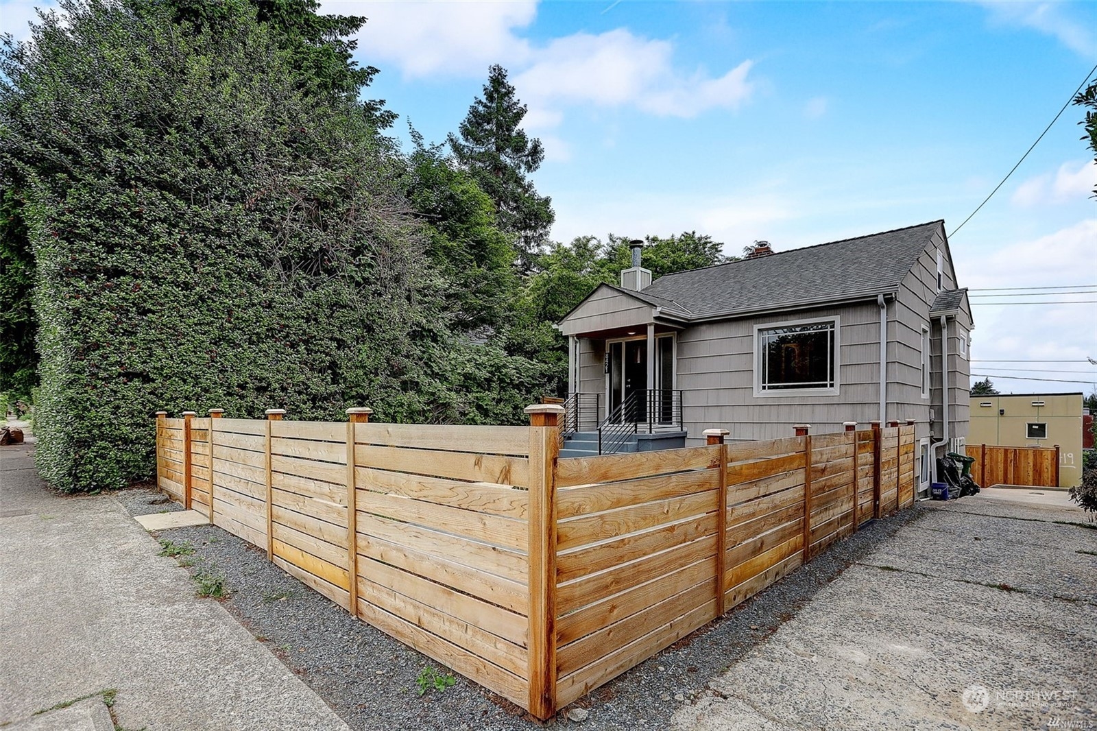 8421 16th Avenue Southwest Seattle, WA 98106 - Photo 2 of 16 a view of a house with backyard and wooden fence
