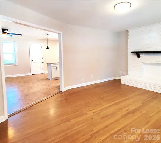 a view of a room with wooden floor and cabinet
