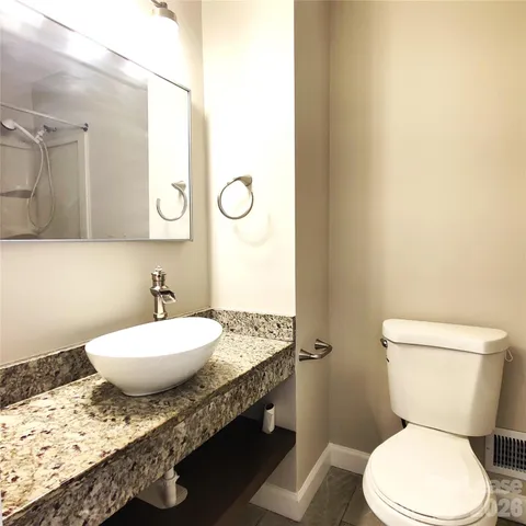 a white toilet sitting next to a bath tub
