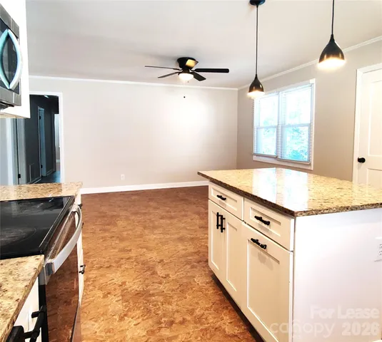 a kitchen with granite countertop a stove and a sink