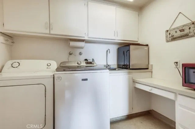 a white refrigerator freezer and a granite counter top