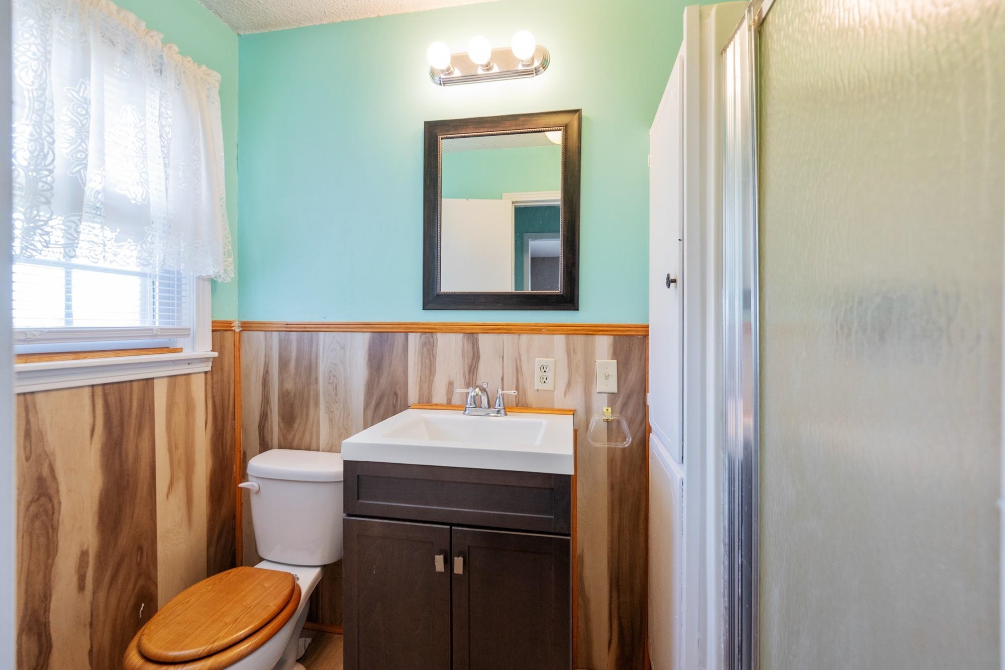 1705 100th Highway West Decaturville, TN 38329 - Photo 13 of 27 a bathroom with a sink a toilet and shower curtain