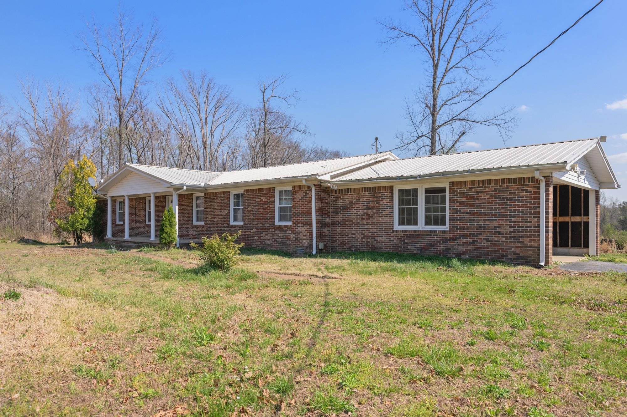 1705 100th Highway West Decaturville, TN 38329 - Photo 25 of 27 a front view of a house with a yard
