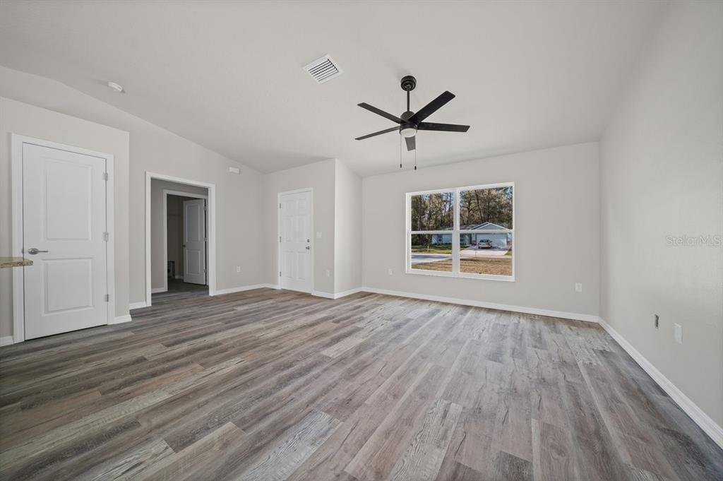 8992 North Lisa Terrace Citrus Springs, FL 34433 - Photo 13 of 25 a view of empty room with wooden floor and window
