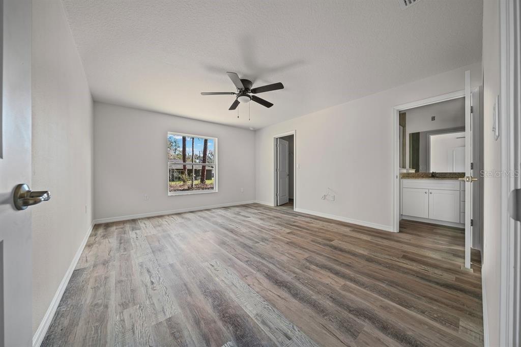 8992 North Lisa Terrace Citrus Springs, FL 34433 - Photo 14 of 25 wooden floor in an empty room with a window