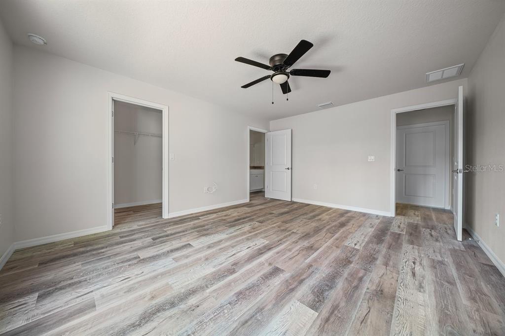 8992 North Lisa Terrace Citrus Springs, FL 34433 - Photo 15 of 25 a view of empty room with wooden floor and window