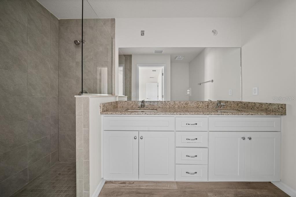 8992 North Lisa Terrace Citrus Springs, FL 34433 - Photo 16 of 25 a bathroom with a granite countertop sink and a mirror