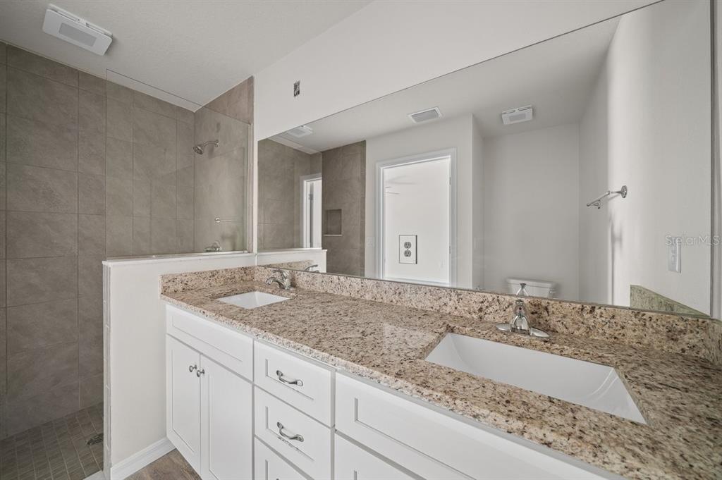 8992 North Lisa Terrace Citrus Springs, FL 34433 - Photo 17 of 25 a bathroom with a granite countertop sink and a mirror