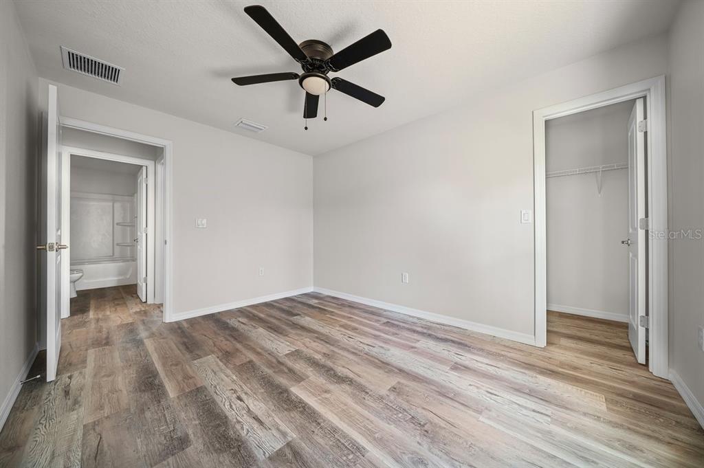 8992 North Lisa Terrace Citrus Springs, FL 34433 - Photo 22 of 25 an empty room with wooden floor and a ceiling fan