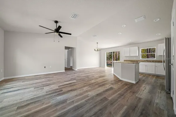 a view of a kitchen with wooden floor and a sink