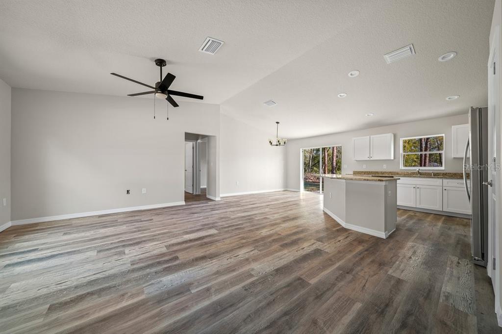 8992 North Lisa Terrace Citrus Springs, FL 34433 - Photo 4 of 25 a view of a kitchen with wooden floor and a sink
