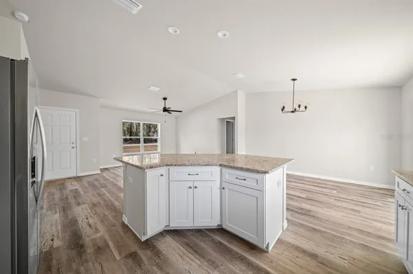 a spacious bathroom with a granite countertop sink and a mirror