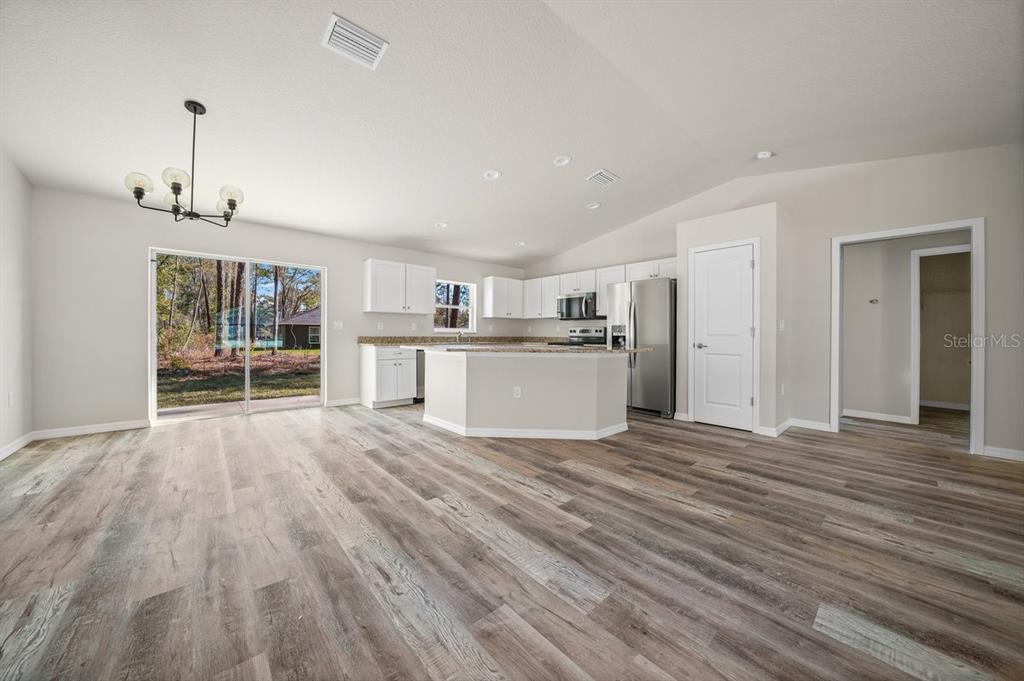 8992 North Lisa Terrace Citrus Springs, FL 34433 - Photo 10 of 25 a view of a kitchen with wooden floor and a window