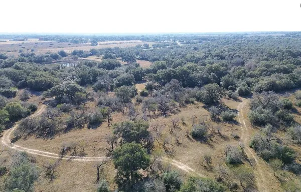 an aerial view of house with yard and mountain view in back