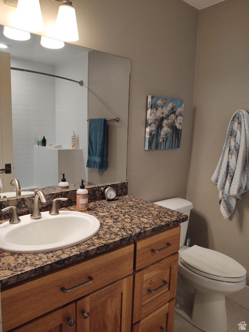 2170 Highway 357 Beaver, UT 84713 - Photo 39 of 56 Vanity with an integrated sink, stone-finish countertop, and wood-finish cabinetry