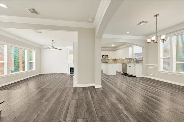 a view of a kitchen with wooden floor and a kitchen