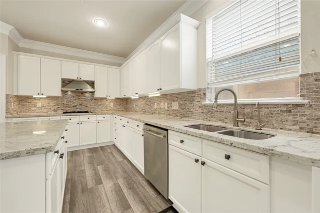 a kitchen with a sink cabinets and window
