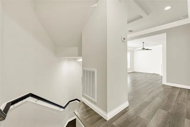 an empty room with wooden floor and closet
