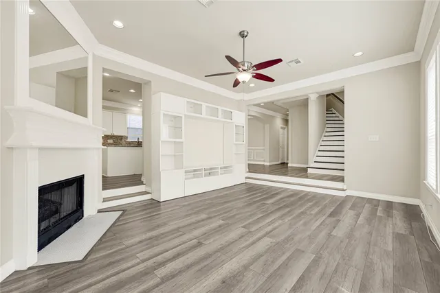 wooden floor in an empty room with a fireplace