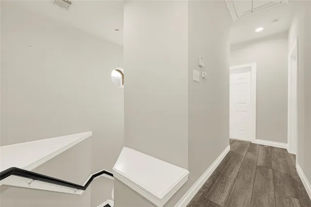 a view of a room with wooden floor and fan
