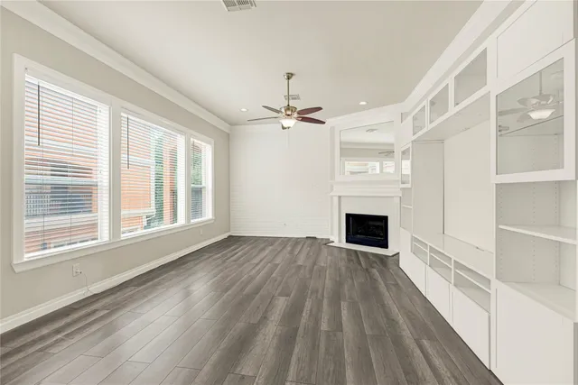a view of a livingroom with a fireplace wooden floor and window