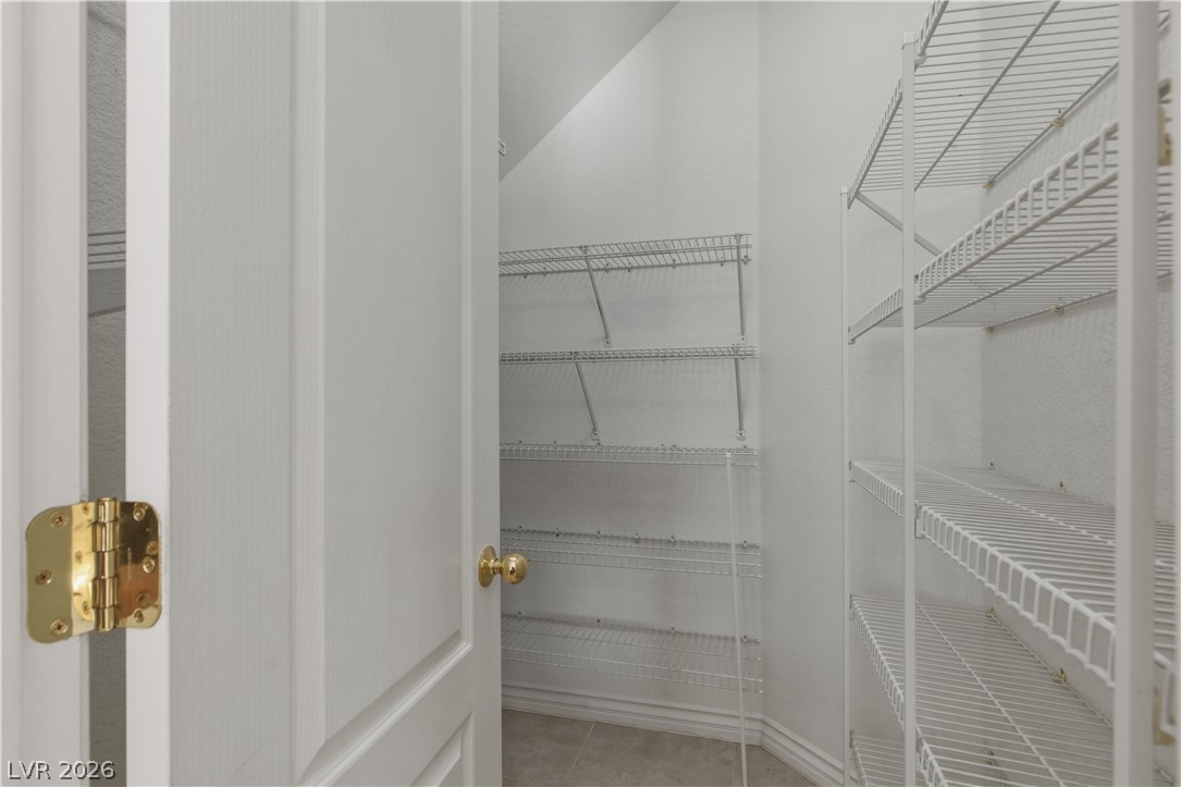 29 Olive Tree Henderson, NV 89074 - Photo 17 of 60 This spacious closet offers organized storage solutions with multiple shelving units.