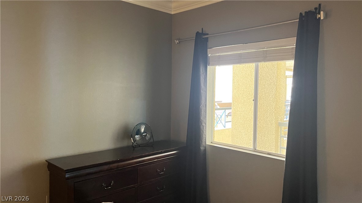 210 East Flamingo Road, Unit 205 Las Vegas, NV 89169 - Photo 10 of 17 Well-lit room with ample space, offering comfortable living and serene relaxation.