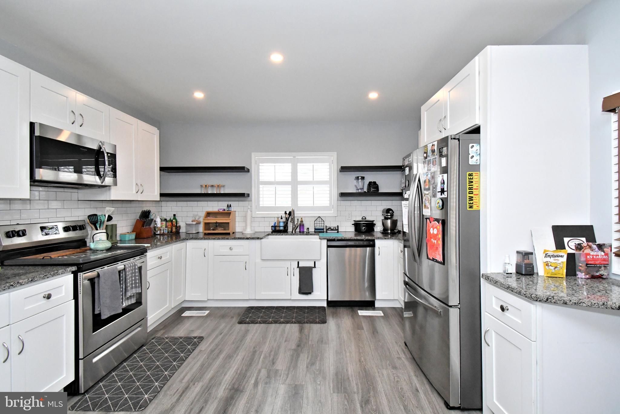 510 North Pleasantview Road Pottstown, PA 19464 - Photo 12 of 37 a kitchen with stainless steel appliances granite countertop a refrigerator stove top oven and sink