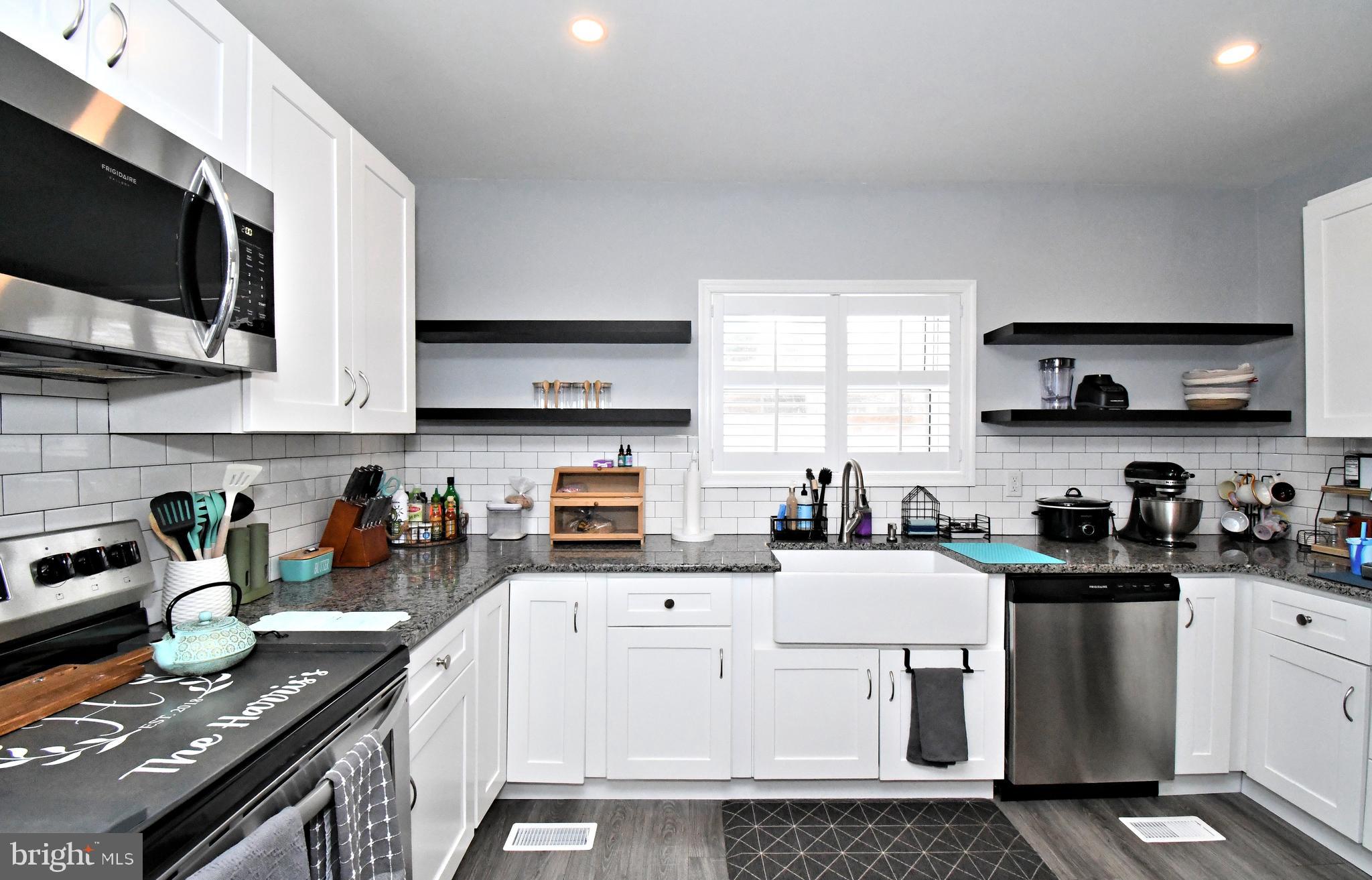 510 North Pleasantview Road Pottstown, PA 19464 - Photo 14 of 37 a kitchen with stainless steel appliances a stove a sink a microwave and cabinets