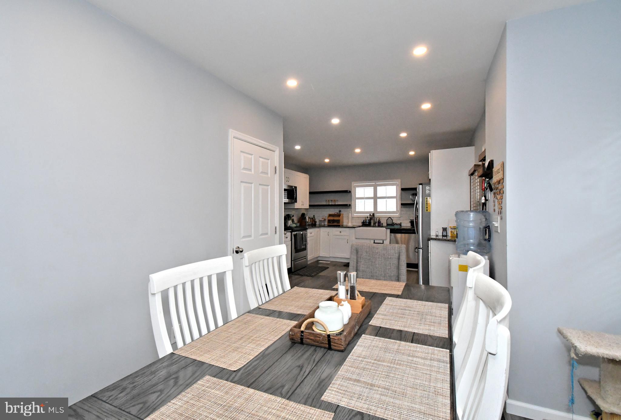 510 North Pleasantview Road Pottstown, PA 19464 - Photo 18 of 37 a living room with furniture and a dining table with kitchen view