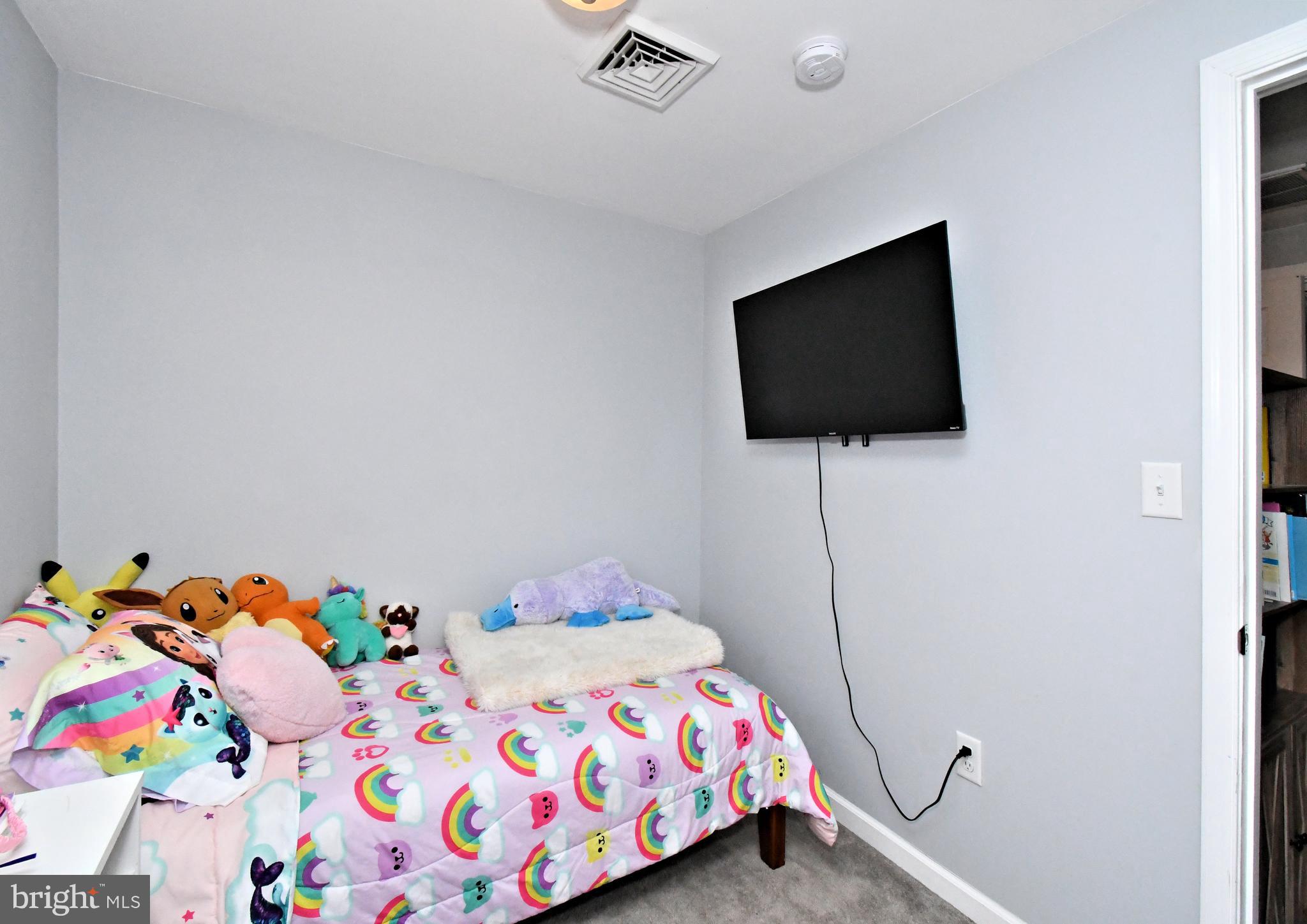 510 North Pleasantview Road Pottstown, PA 19464 - Photo 25 of 37 a bedroom with a bed and a flat screen tv