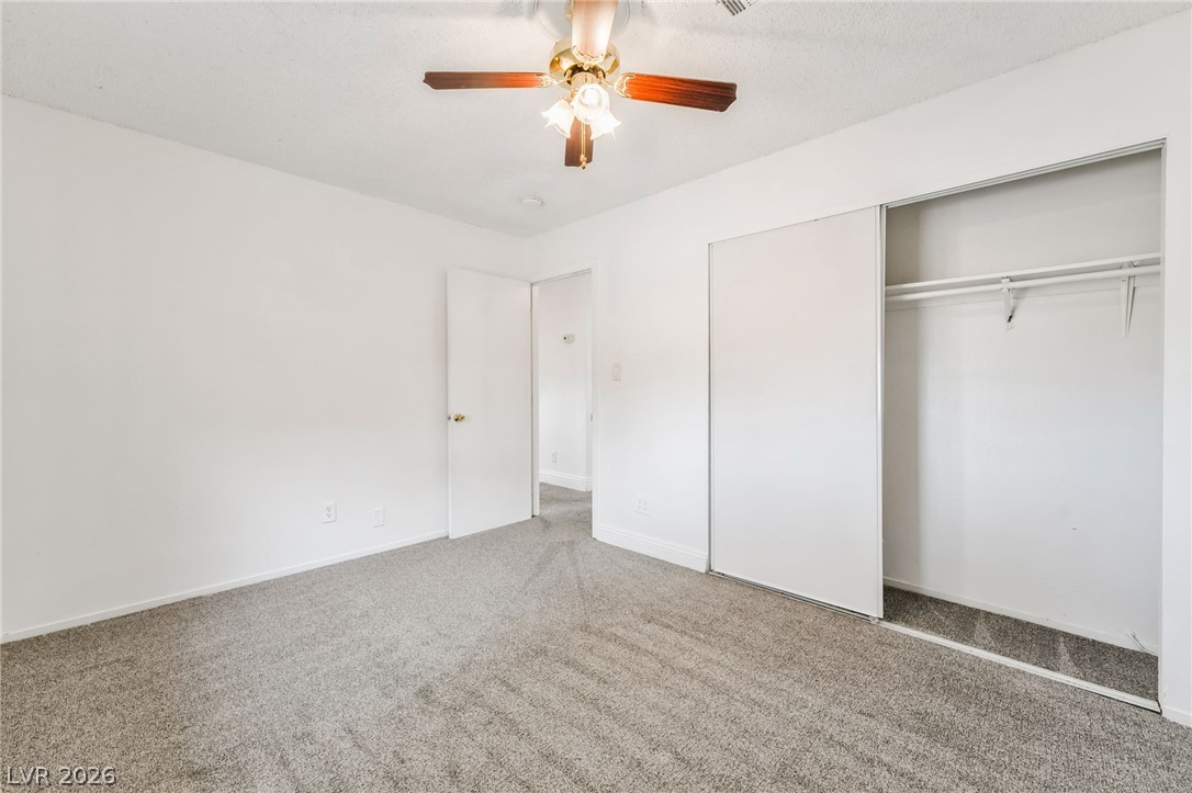 242 Nebraska Avenue Henderson, NV 89015 - Photo 40 of 46 Bedroom 1 with carpet, a closet, and a ceiling fan