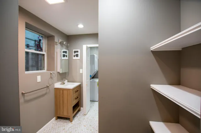 a bathroom with a sink mirror and toilet