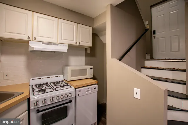 a kitchen with a stove and a microwave