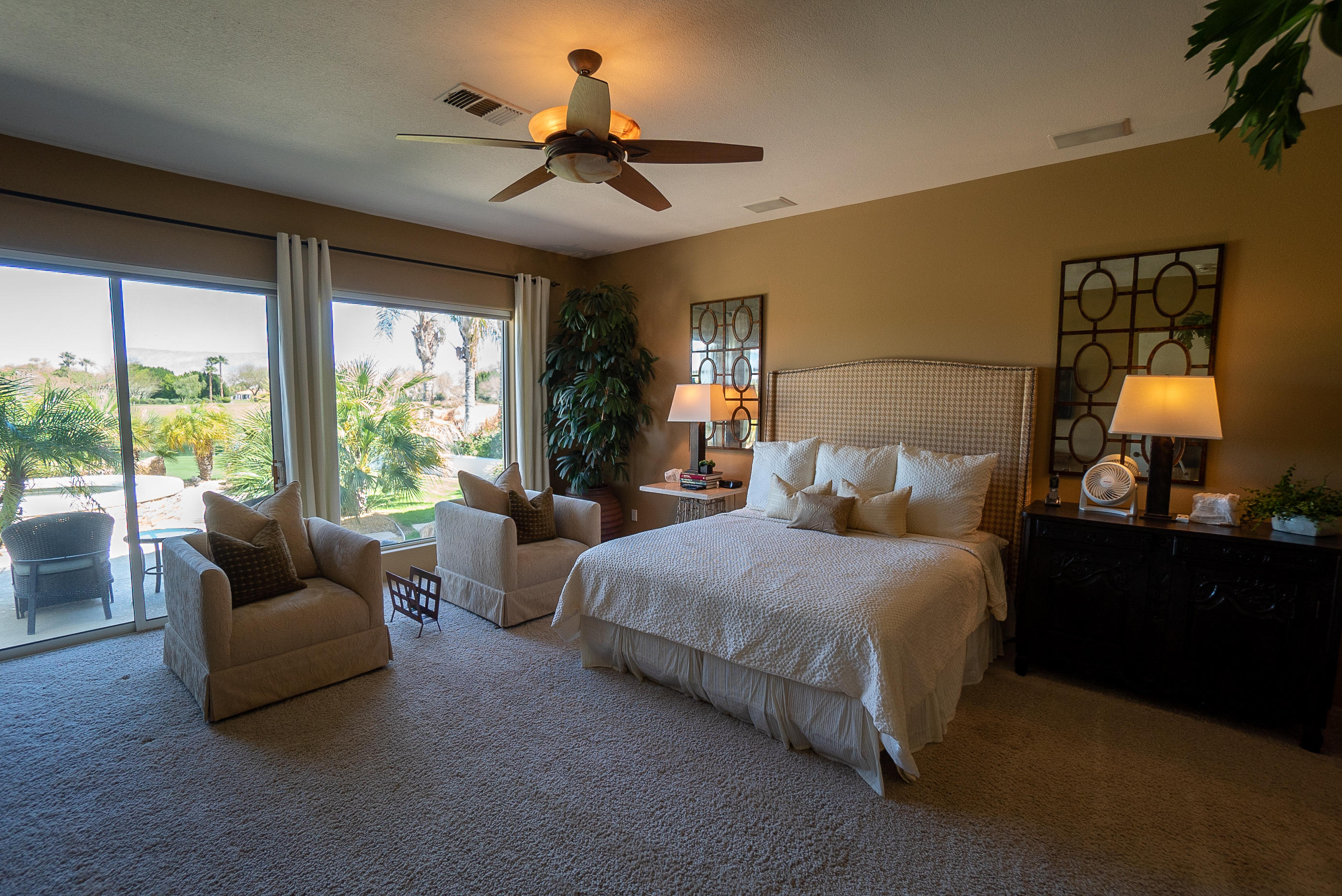 144 Loch Lomond Road Rancho Mirage, CA 92270 - Photo 17 of 28 a bedroom with bed couch and window