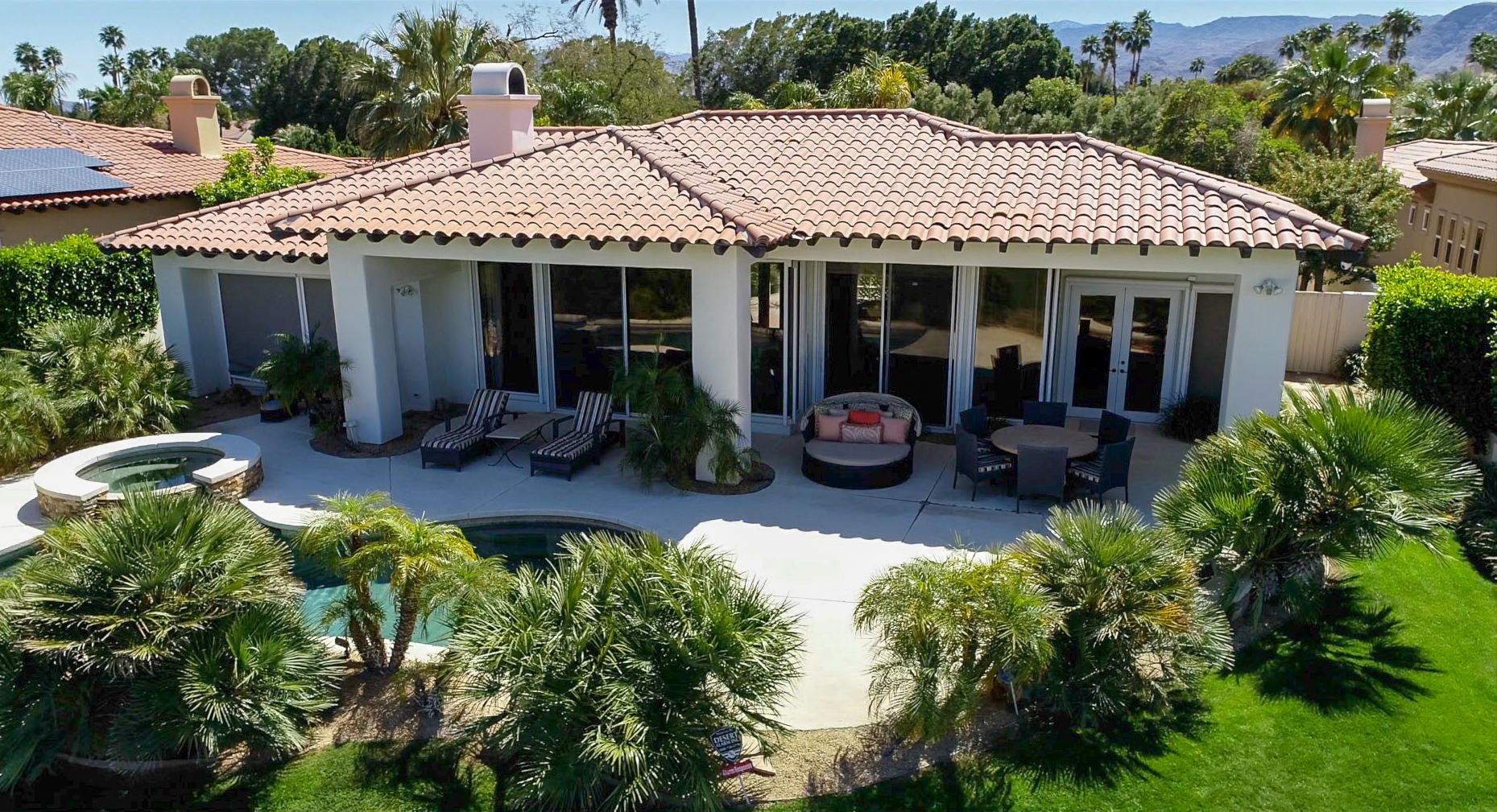 144 Loch Lomond Road Rancho Mirage, CA 92270 - Photo 2 of 28 a front view of a house with a garden and porch