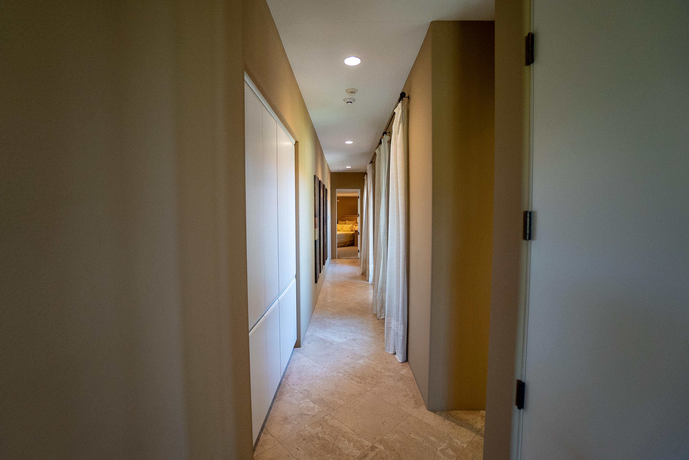 144 Loch Lomond Road Rancho Mirage, CA 92270 - Photo 22 of 28 a view of a hallway with wooden shelves