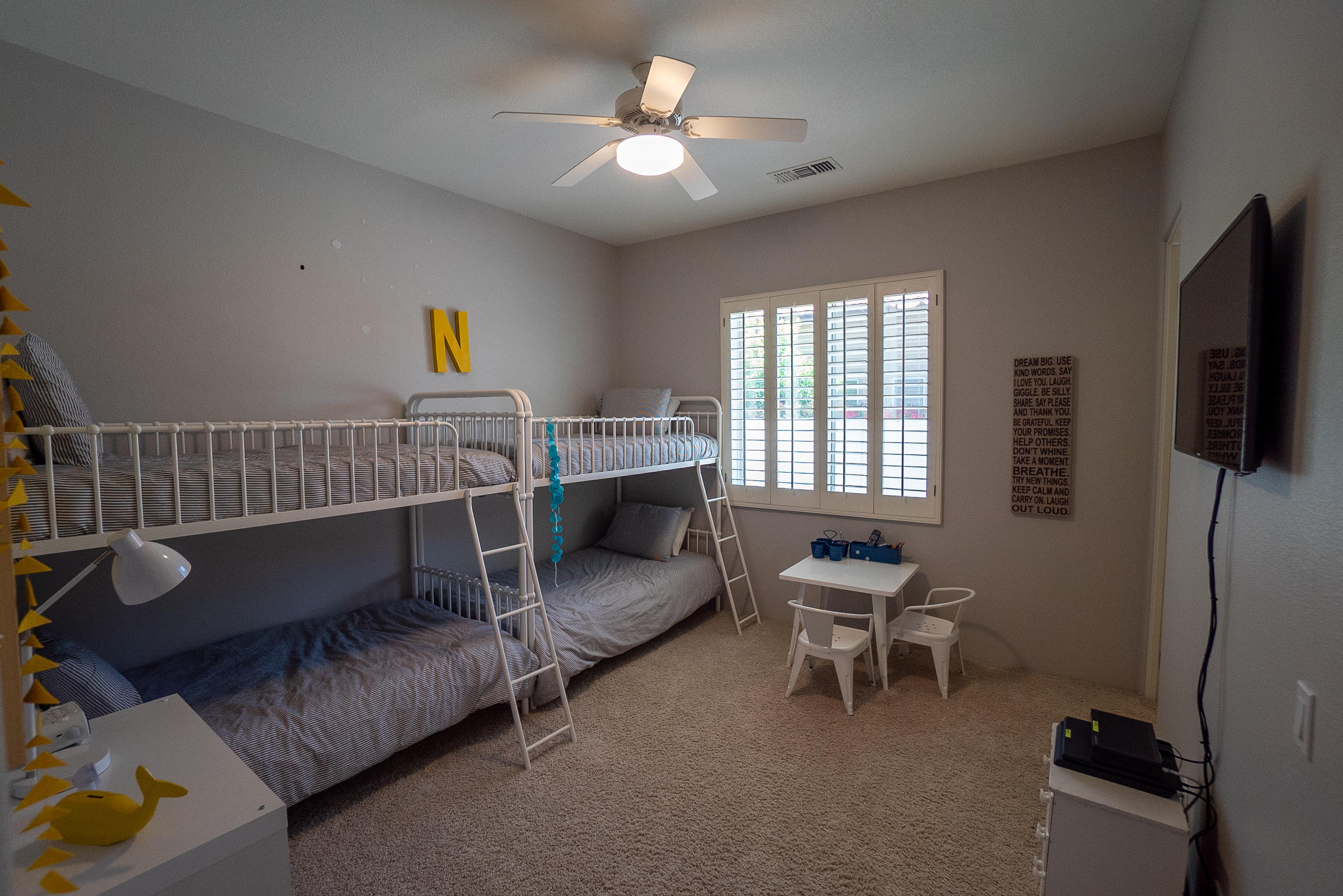 144 Loch Lomond Road Rancho Mirage, CA 92270 - Photo 23 of 28 a bedroom with a bed and a chandelier