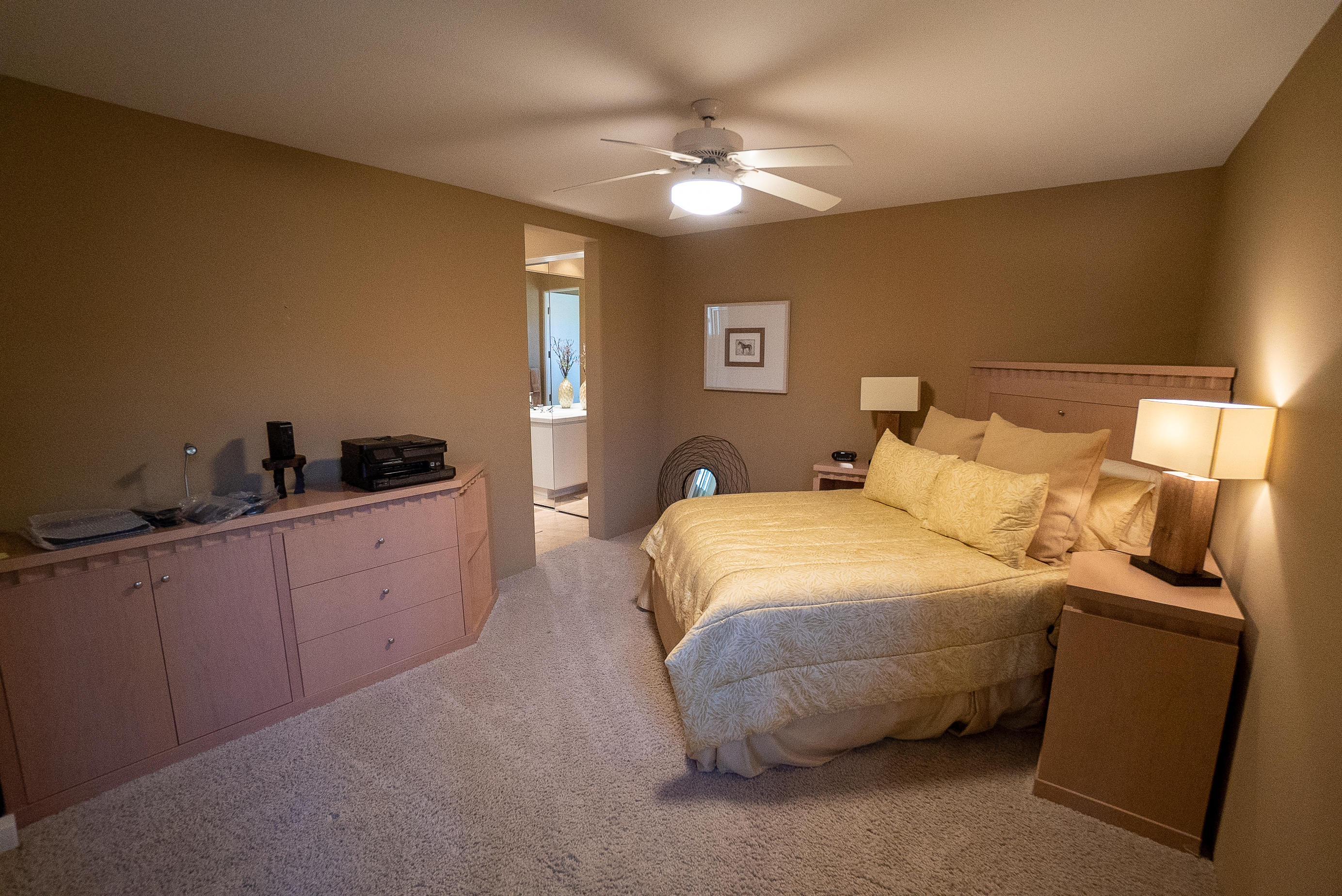 144 Loch Lomond Road Rancho Mirage, CA 92270 - Photo 25 of 28 a bedroom with a bed and a chandelier