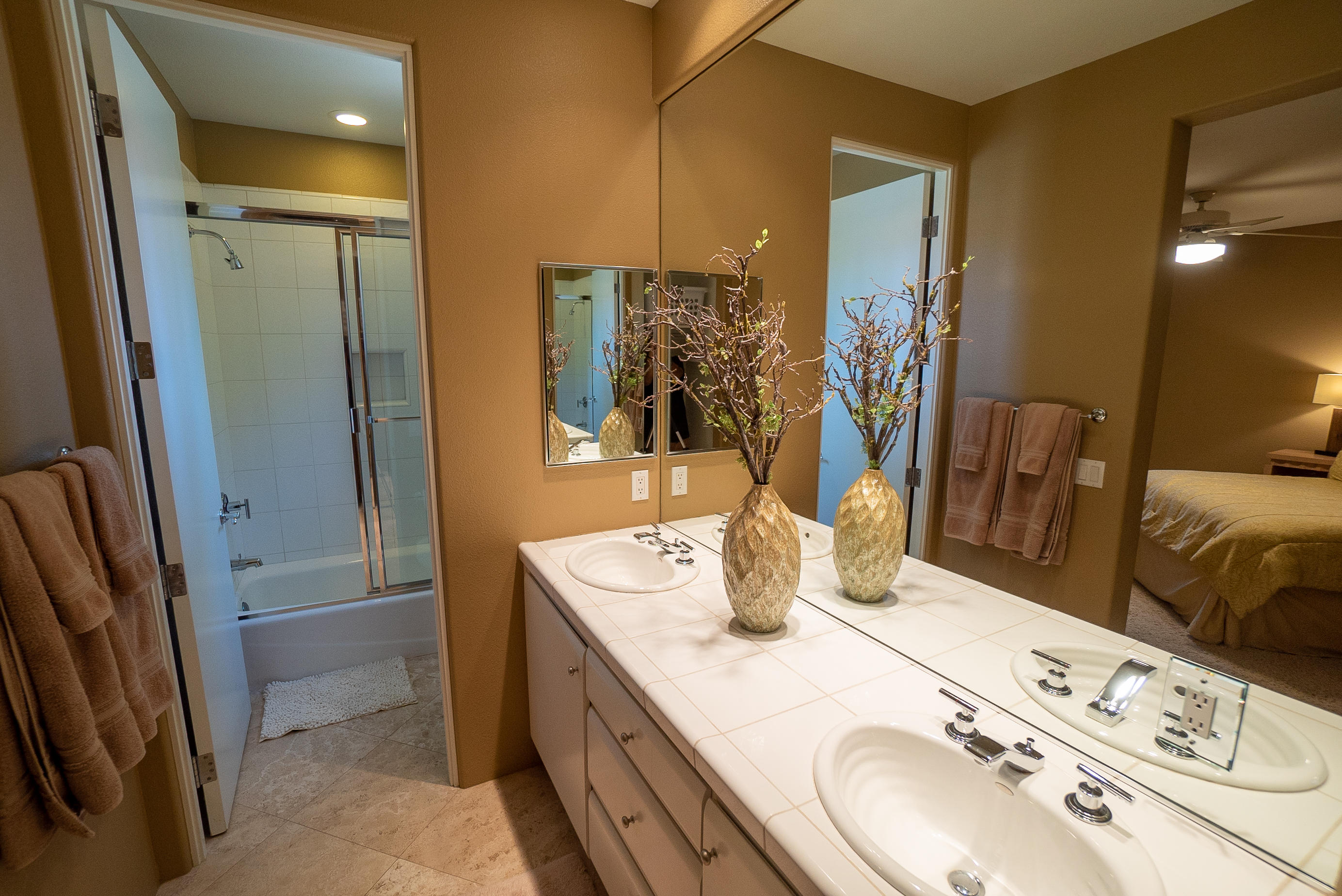 144 Loch Lomond Road Rancho Mirage, CA 92270 - Photo 26 of 28 a bathroom with a double vanity sink a mirror and shower