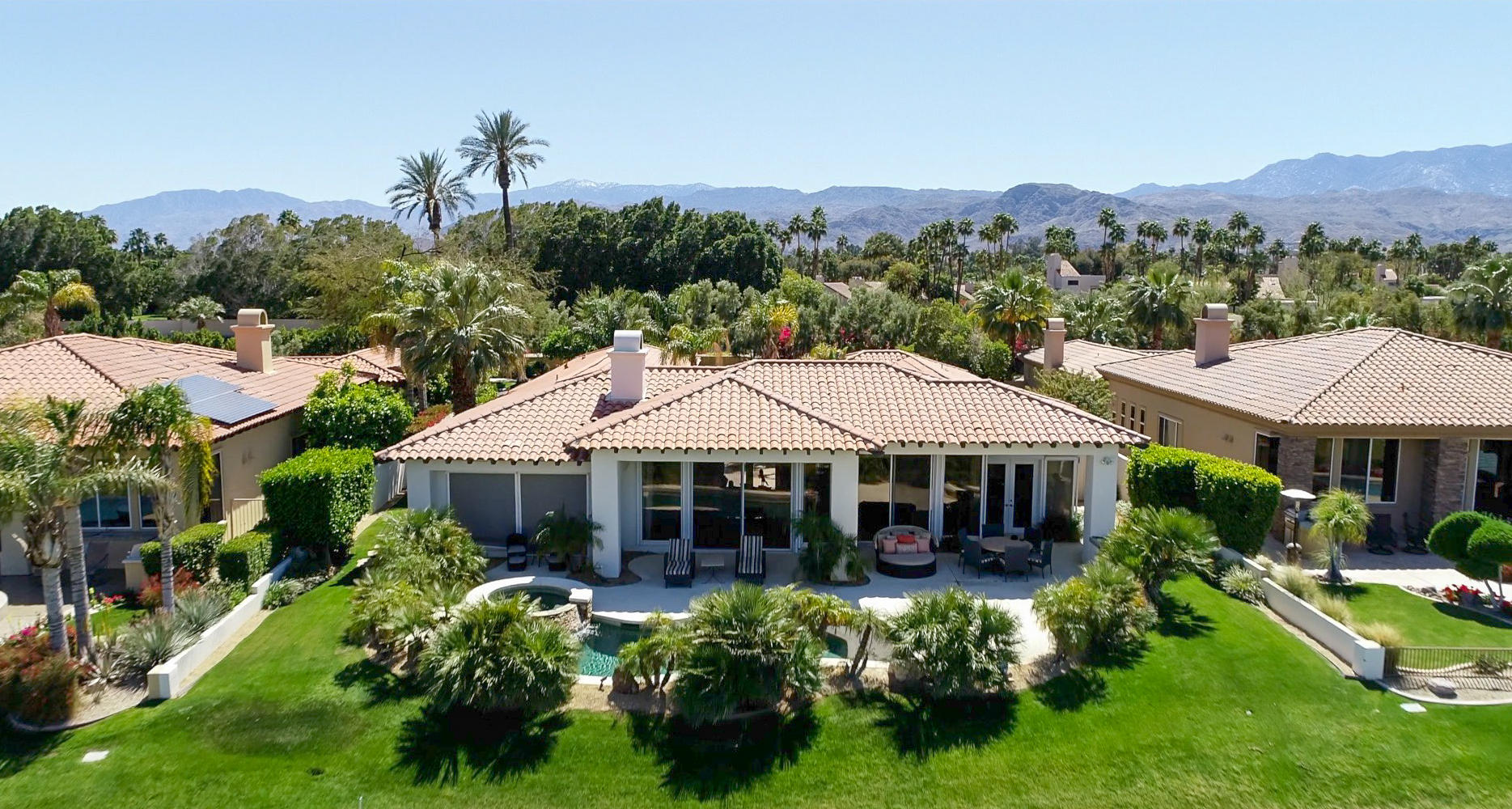 144 Loch Lomond Road Rancho Mirage, CA 92270 - Photo 3 of 28 a front view of a house with a yard and a fountain