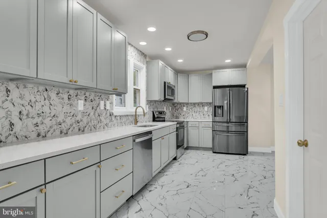 a kitchen with white cabinets and white appliances