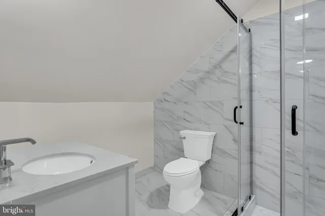 a bathroom with a toilet sink and a shower