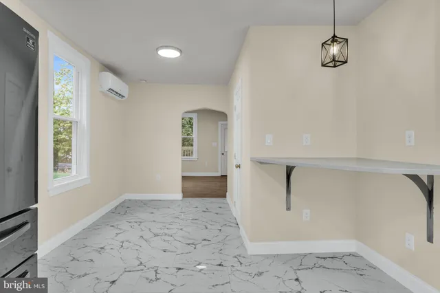 a view of a big room with windows and cabinet