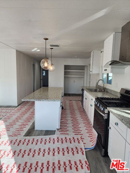 17700 South Avalon Boulevard, Unit 221 Carson, CA 90746 - Photo 3 of 14 a large kitchen with stainless steel appliances granite countertop a sink dishwasher stove and refrigerator