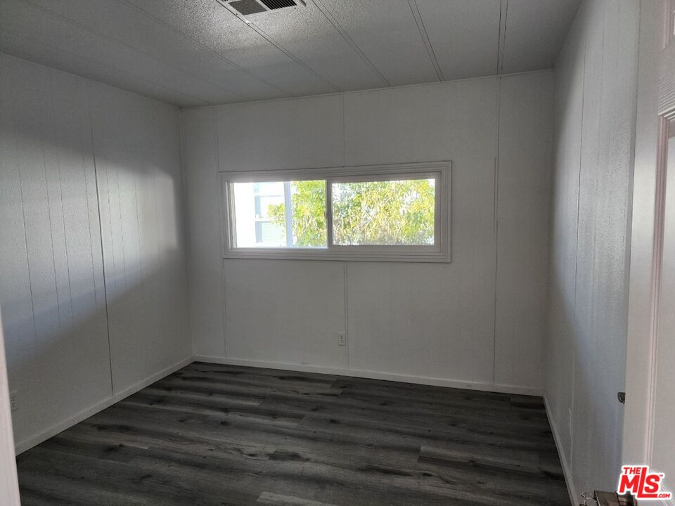 17700 South Avalon Boulevard, Unit 221 Carson, CA 90746 - Photo 4 of 14 an empty room with wooden floor and windows
