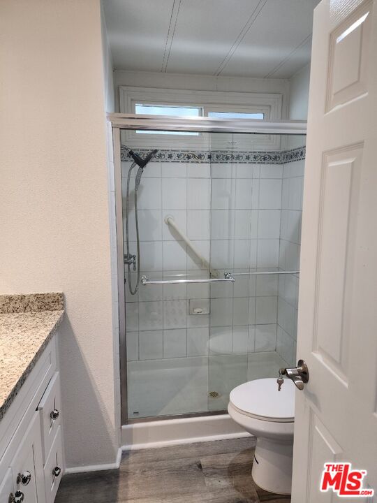 17700 South Avalon Boulevard, Unit 221 Carson, CA 90746 - Photo 8 of 14 a bathroom with a granite countertop shower a toilet and a sink