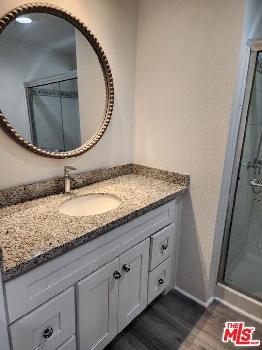 17700 South Avalon Boulevard, Unit 221 Carson, CA 90746 - Photo 9 of 14 a bathroom with a granite countertop sink a mirror and vanity