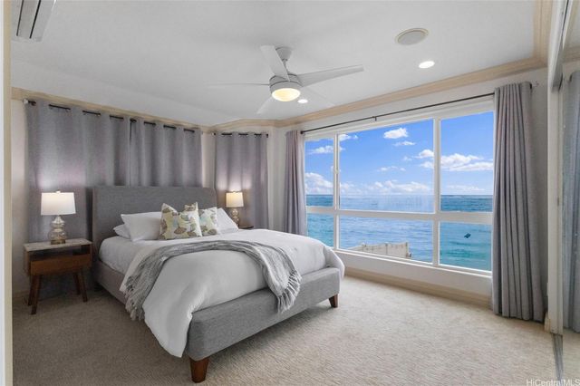 a spacious bedroom with a bed and a large window